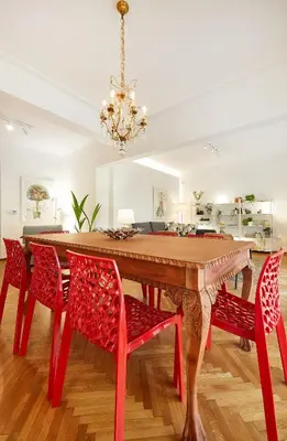 a dining room with a red table and chairs at Chloe Boutique Apartments Nikis in Athens