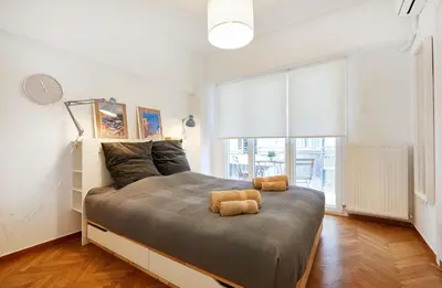 a bedroom with a bed with two teddy bears on it at Chloe Boutique Apartments Nikis in Athens