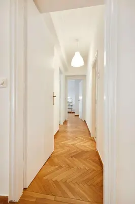 an empty hallway with white walls and wood floors at Chloe Boutique Apartments Nikis in Athens