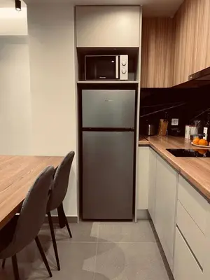 a kitchen with a refrigerator with a microwave on top at Small Meisonette Near The Metro VIPGreece in Athens