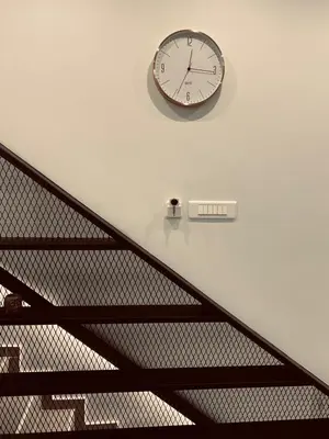 a clock on a wall next to a staircase at Small Meisonette Near The Metro VIPGreece in Athens