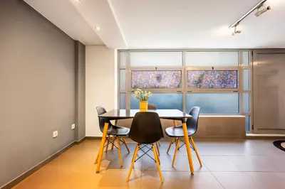 a dining room with a table and chairs at Stylish 2BR Koukaki l Balcony & Work-Friendly Desk in Athens