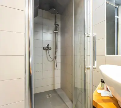 a bathroom with a shower and a sink at Stylish 2BR Koukaki l Balcony & Work-Friendly Desk in Athens