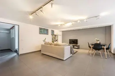 a living room with a couch and a table at Stylish 2BR Koukaki l Balcony & Work-Friendly Desk in Athens