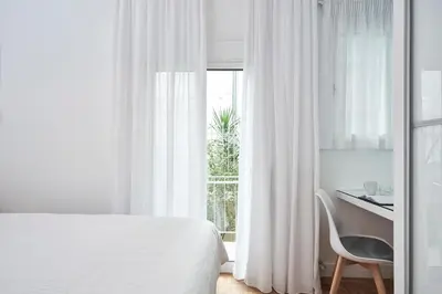 a bedroom with a bed and a desk and a window at Elite Living 2bd Apt next to Hilton-Ilisia Park in Athens