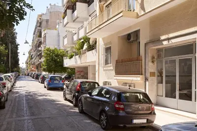 a row of cars parked on the side of a street at Elite Living 2bd Apt next to Hilton-Ilisia Park in Athens