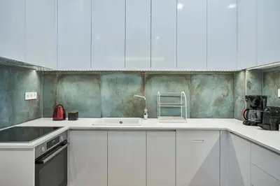 a kitchen with white cabinets and a sink at Elite Living 2bd Apt next to Hilton-Ilisia Park in Athens