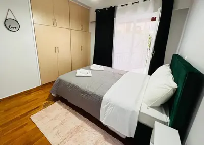a bedroom with a bed and a window at Acropolis Select Flat in Athens