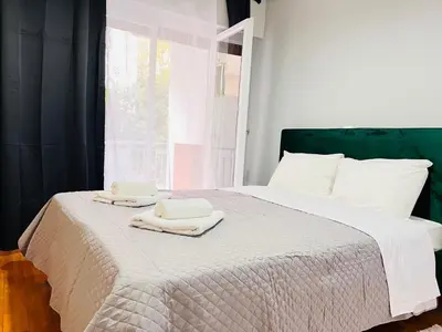 a bedroom with a bed with two towels on it at Acropolis Select Flat in Athens