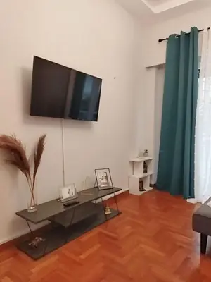 a living room with a flat screen tv on the wall at Acropolis Select Flat in Athens
