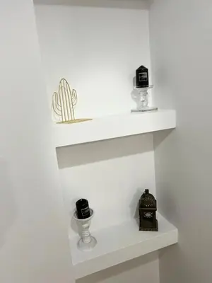 a white shelf with a cactus and a clock on it at Acropolis Select Flat in Athens