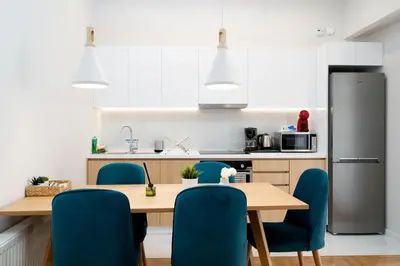 a kitchen with a wooden table and blue chairs at The Athens Gathering, Hip area and sightseeing in Athens