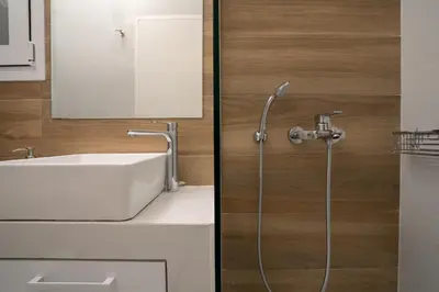 a bathroom with a sink and a shower at The Athens Gathering, Hip area and sightseeing in Athens