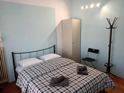 a bedroom with a bed with two hats on it at Rooms in the apartment (Leontiou) in Athens