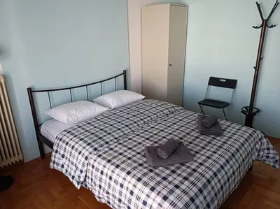 a bedroom with a bed with two towels on it at Rooms in the apartment (Leontiou) in Athens