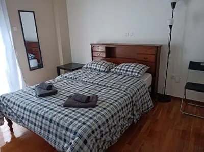 a bedroom with a bed with two towels on it at Rooms in the apartment (Leontiou) in Athens