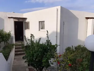 a white house with a staircase leading to a door at Breezy summer maisonette with exciting view! in Aghia Marina