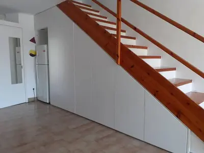 a room with a staircase and a refrigerator at Breezy summer maisonette with exciting view! in Aghia Marina
