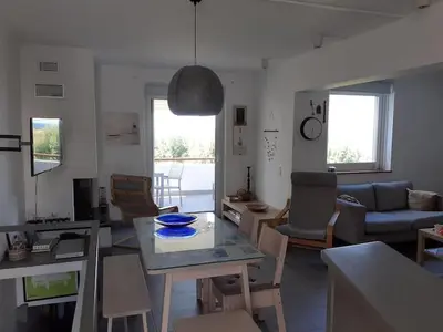 a living room with a table and a couch at Breezy summer maisonette with exciting view! in Aghia Marina