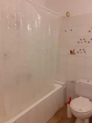 a bathroom with a white tub and a toilet at Breezy summer maisonette with exciting view! in Aghia Marina