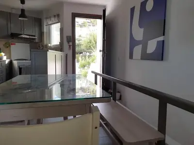 a kitchen with a glass counter top in a room at Breezy summer maisonette with exciting view! in Aghia Marina