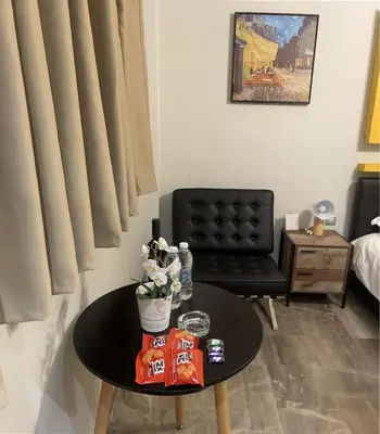 a living room with a table and a chair at WUKELA APARTMENTS in Athens