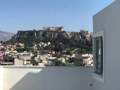 a view of the acropolis from a house window at WUKELA APARTMENTS in Athens