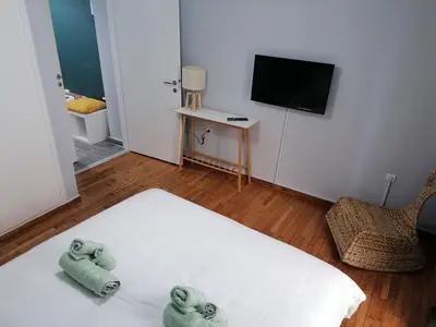 a bedroom with a bed with two towels on it at Boho Studio / Hilton Area-Μέγαρο Μουσικής / Athens in Athens