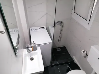 a bathroom with a sink and a toilet and a shower at Boho Studio / Hilton Area-Μέγαρο Μουσικής / Athens in Athens