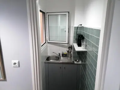 a small bathroom with a sink and a window at Boho Studio / Hilton Area-Μέγαρο Μουσικής / Athens in Athens