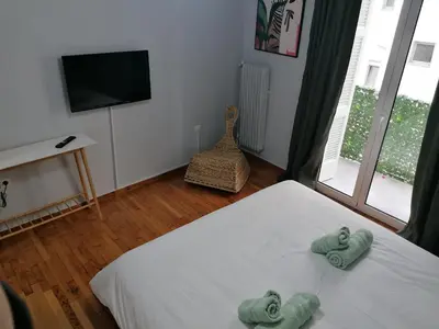 a bedroom with a bed with two towels on it at Boho Studio / Hilton Area-Μέγαρο Μουσικής / Athens in Athens