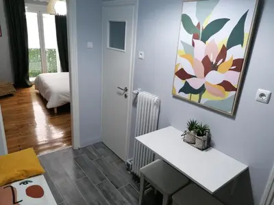 a room with a table and a painting on the wall at Boho Studio / Hilton Area-Μέγαρο Μουσικής / Athens in Athens