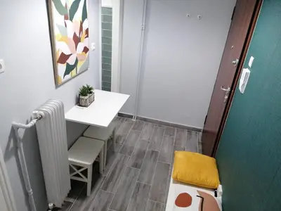 a small room with a table and a radiator at Boho Studio / Hilton Area-Μέγαρο Μουσικής / Athens in Athens