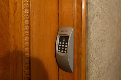 a remote control hanging on a wooden door at Bang in Kolonaki by Athenian Homes in Athens