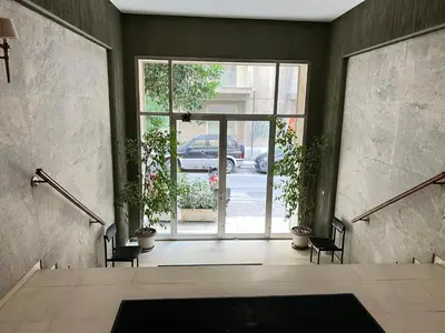 an empty room with a large glass door with plants at Bang in Kolonaki by Athenian Homes in Athens