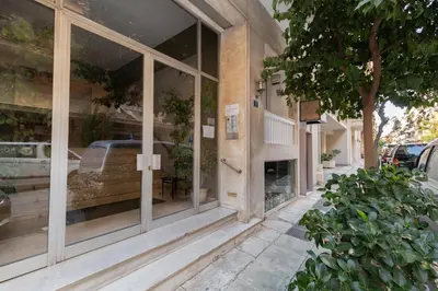 a store front with glass windows on a street at Bang in Kolonaki by Athenian Homes in Athens