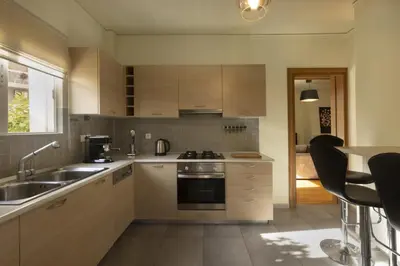 a kitchen with a sink and a stove top oven at 3BR Prime APT a breath away from the Acropolis! in Athens