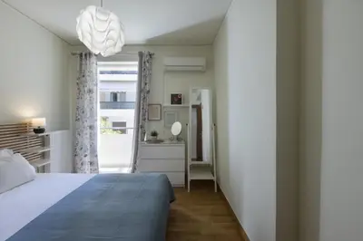 a bedroom with a bed and a window at 3BR Prime APT a breath away from the Acropolis! in Athens