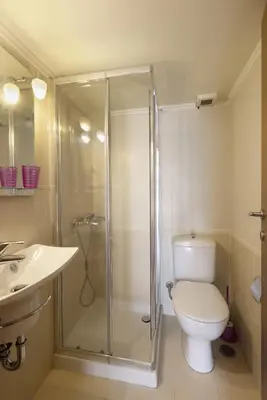 a bathroom with a shower and a toilet and a sink at 3BR Prime APT a breath away from the Acropolis! in Athens