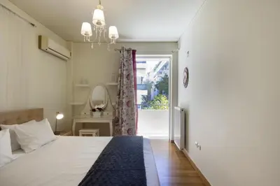 a bedroom with a bed and a sliding glass door at 3BR Prime APT a breath away from the Acropolis! in Athens