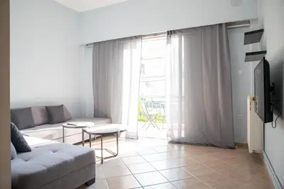 a living room with a couch and a table at Nikea apartment near Piraeus port and metro st II in Piraeus