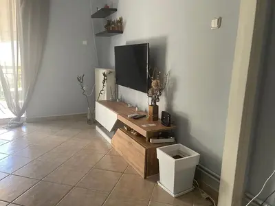 a living room with a flat screen tv on the wall at Nikea apartment near Piraeus port and metro st II in Piraeus