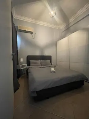 a bedroom with a bed in a room with a light at Nikea apartment near Piraeus port and metro st II in Piraeus