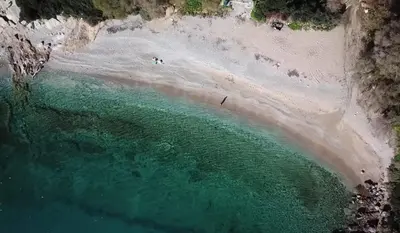 an aerial view of a beach with people in the water at Eclectic Apartment with Stunning Seaview in Porto Rafti