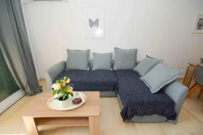 a living room with a couch and a table at Eclectic Apartment with Stunning Seaview in Porto Rafti