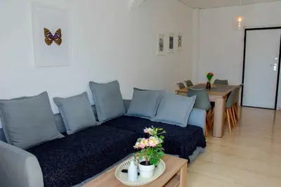 a living room with a couch and a table at Eclectic Apartment with Stunning Seaview in Porto Rafti