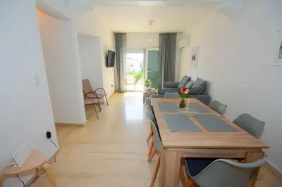 a living room with a table and a couch at Eclectic Apartment with Stunning Seaview in Porto Rafti