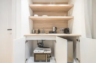 a small kitchen with a sink and a microwave at The Asprogeraka - self check-in rooms in Athens