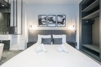a bedroom with a large white bed with two pillows at The Asprogeraka - self check-in rooms in Athens