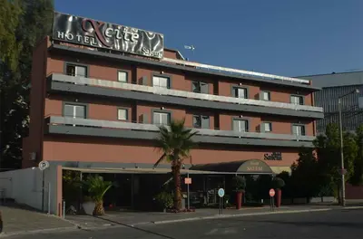 a building with a sign on the top of it at Xcite Hotel Salem in Athens